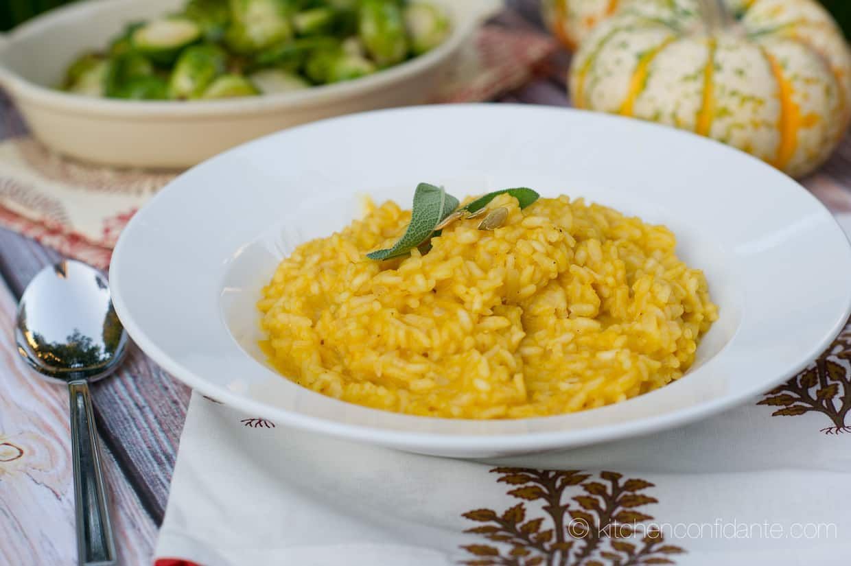 A bowl of rice with a spoon in it on a table.