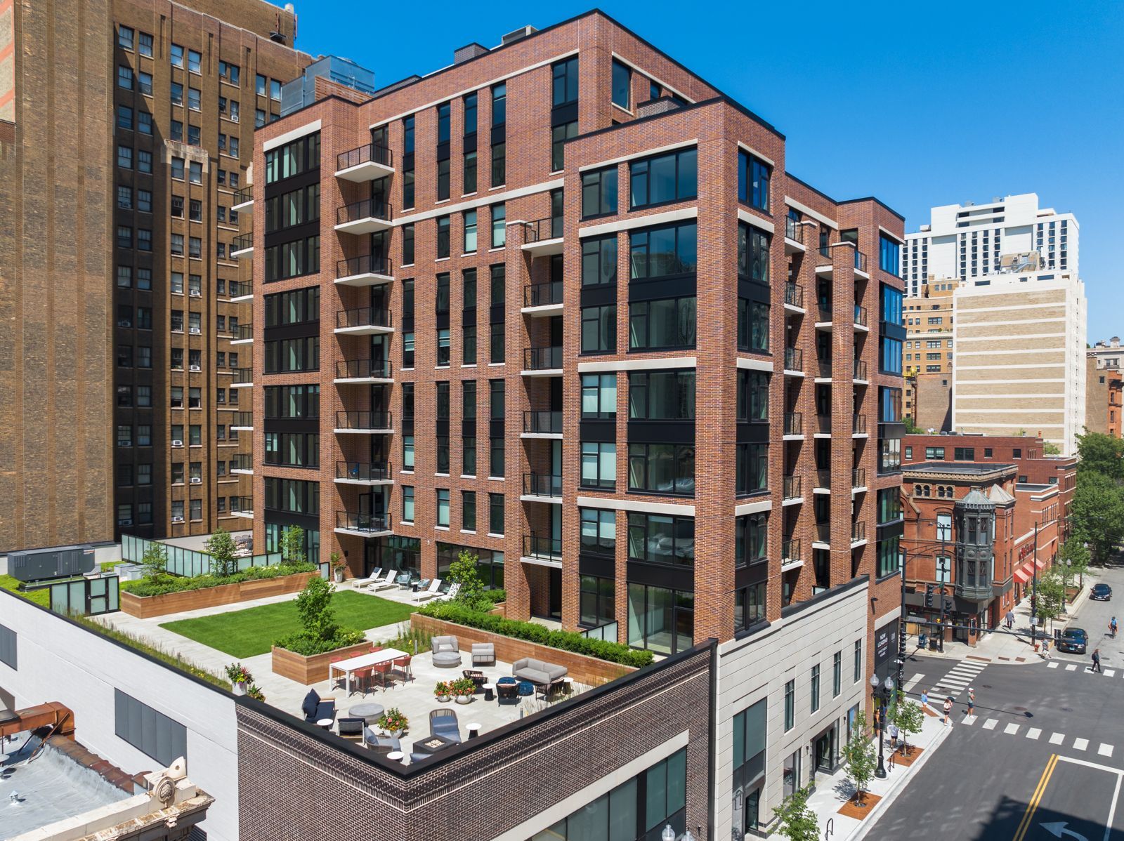 Exterior view of the apartment building with outdoor resident area at Gild.