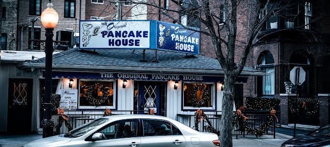 A car is parked in front of a pancake house