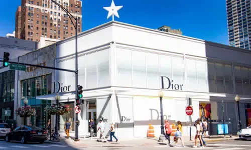 A dior store is located on the corner of a city street.
