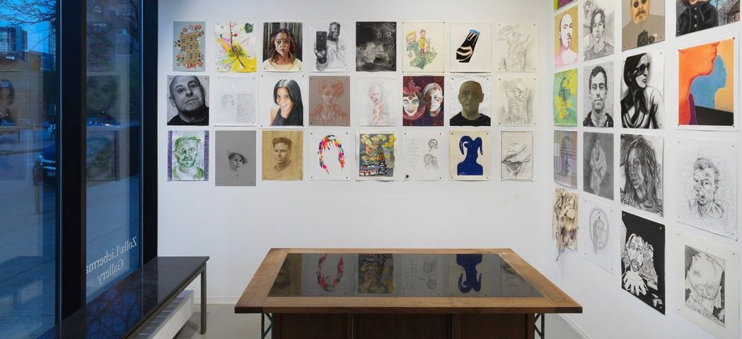 A room with a table and a lot of pictures on the wall.