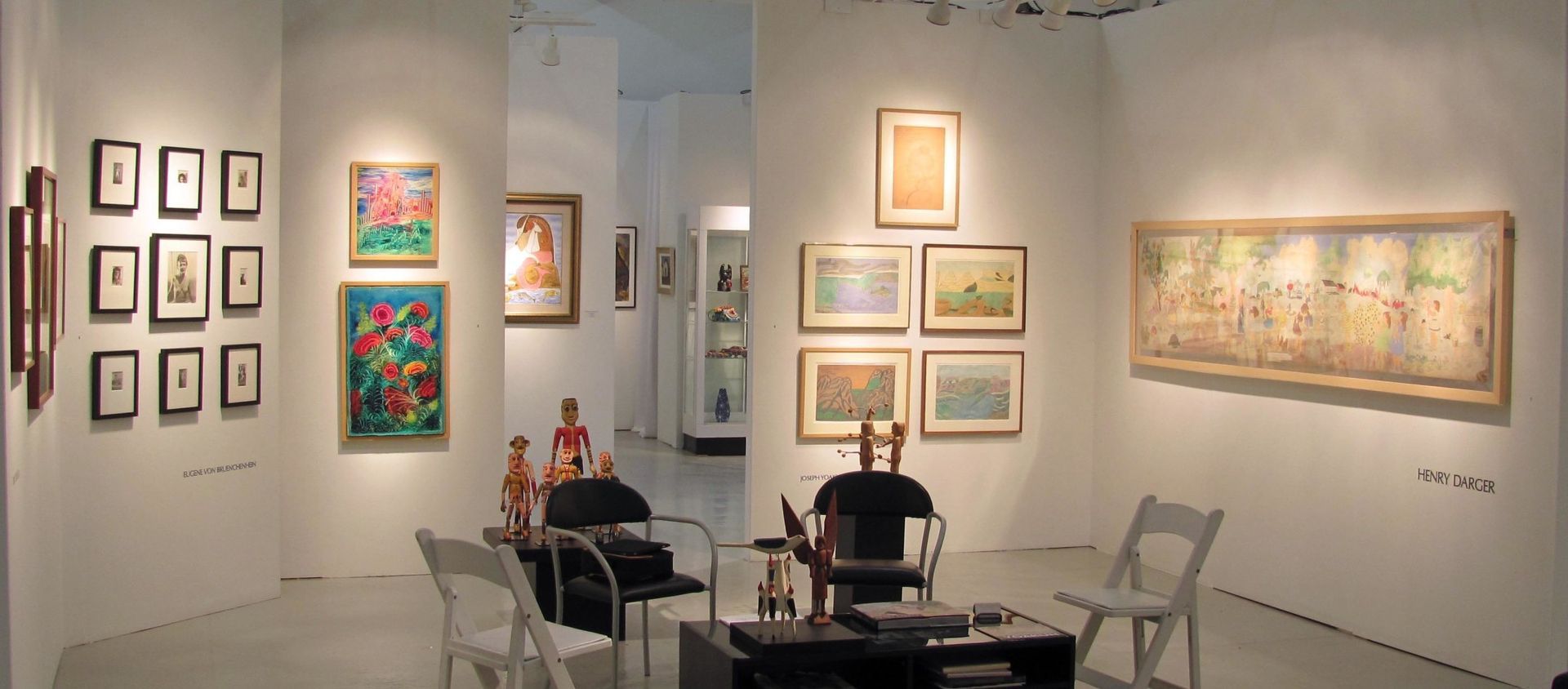 A room with a lot of paintings on the wall.