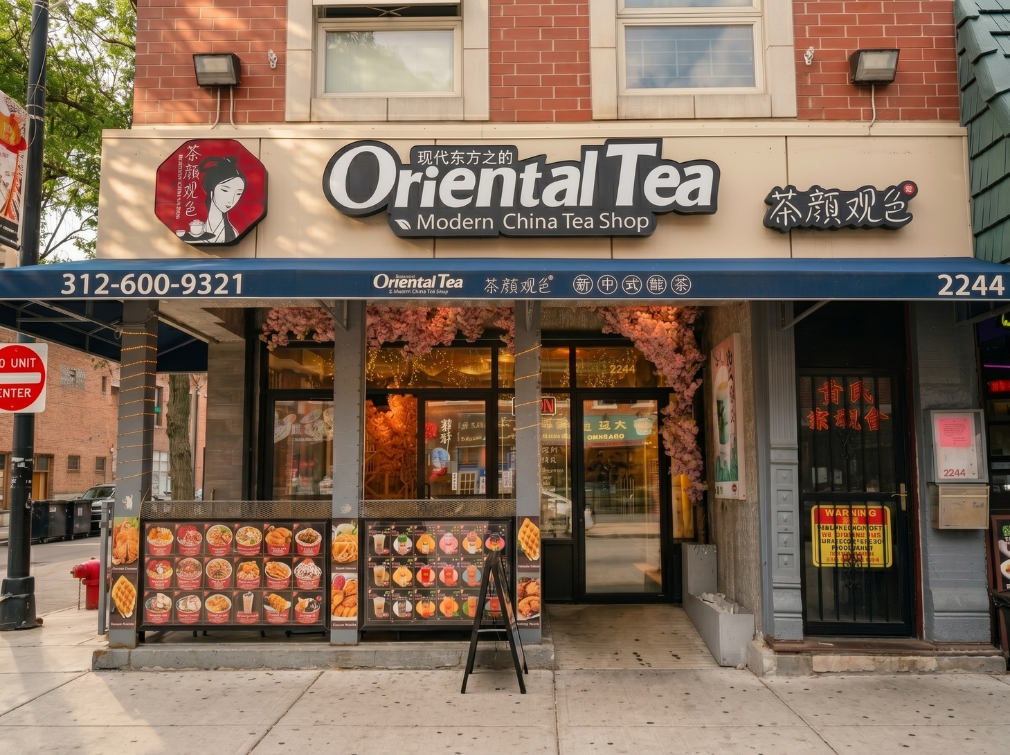 Storefront of Oriental Tea cafe with black signage, red logo, and sidewalk menu boards on a city street