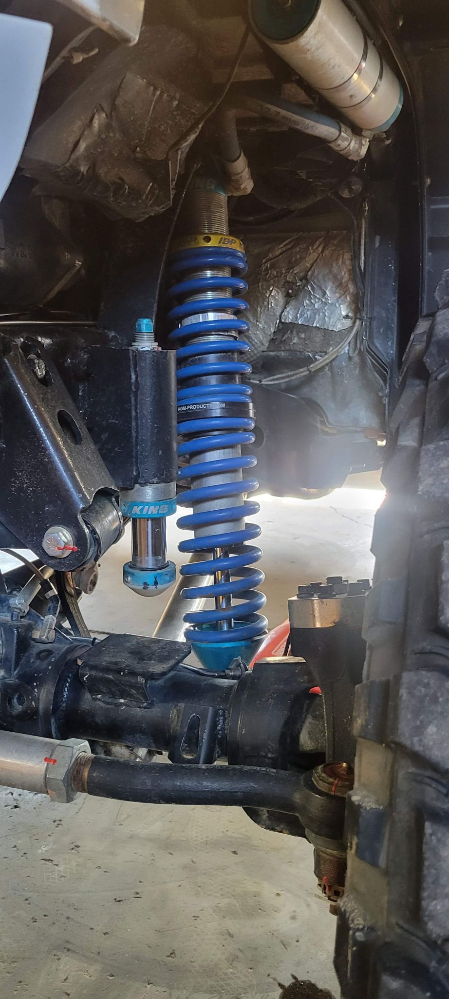 Rusty automotive differential and brake components on a workbench in a garage