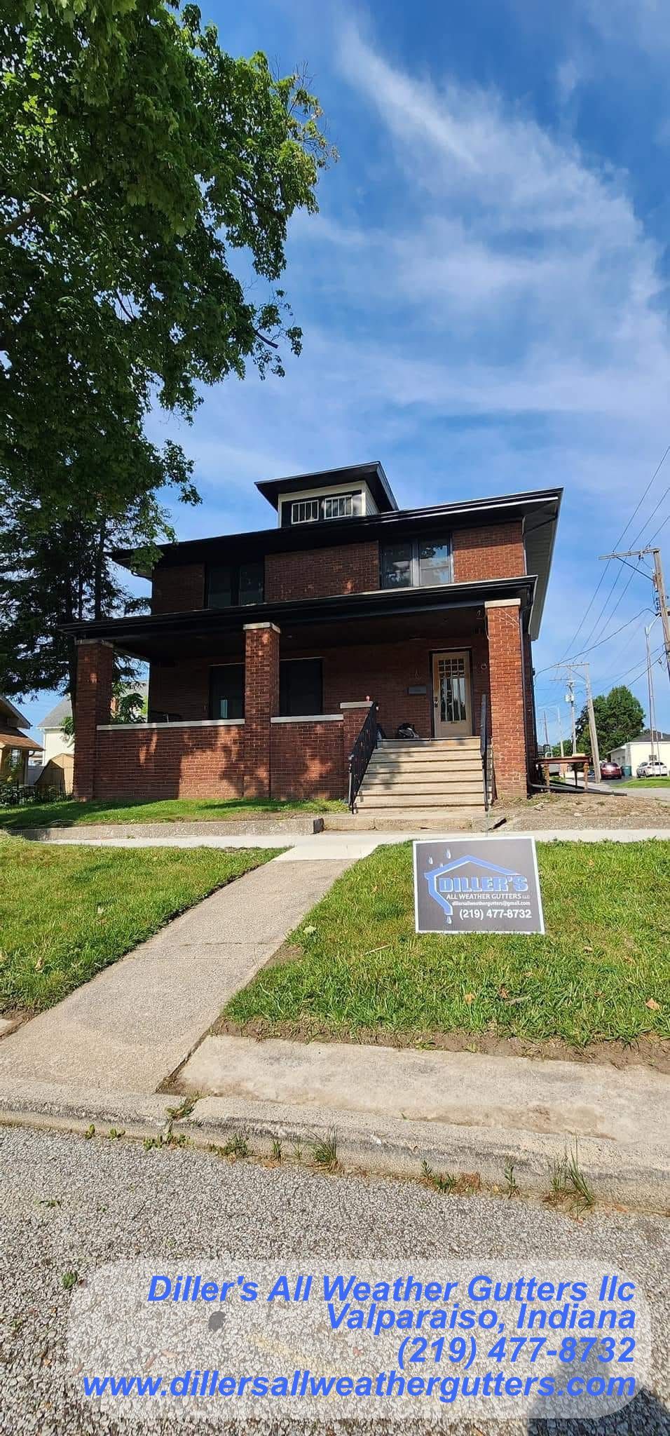 A brick house with a sign in front of it is for sale. Gutter installation in Northwestern Indiana