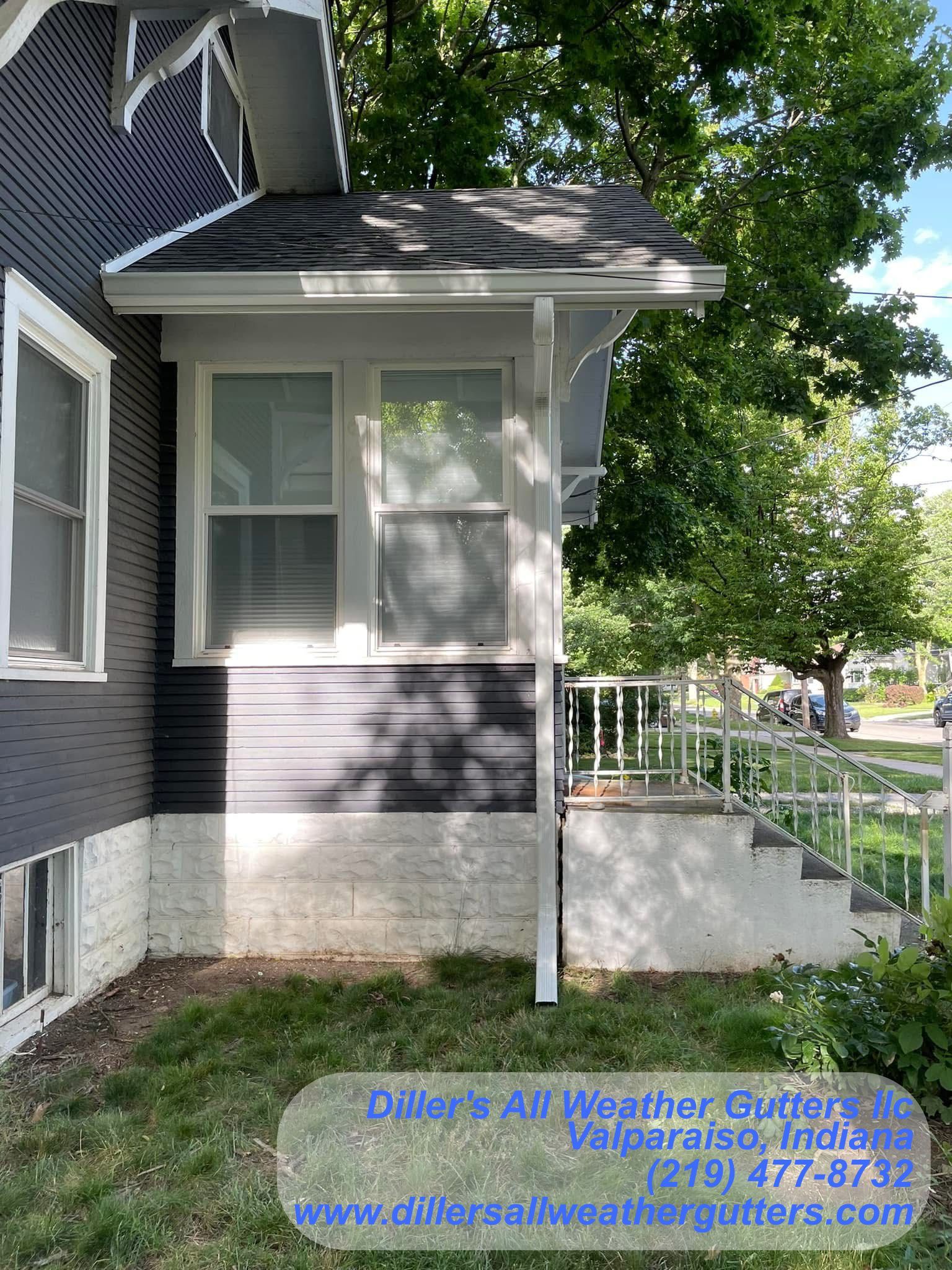 The front of a house with a porch and stairs. Gutter installation in Northwestern Indiana