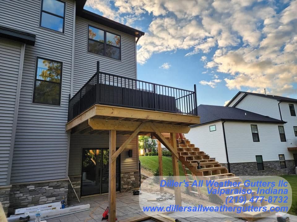 A wooden deck is being built on the back of a house. Gutter installation in Northwestern Indiana