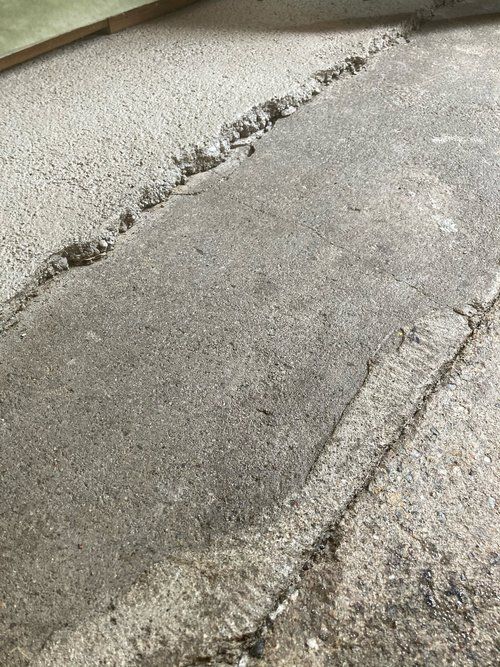 A close up of a concrete floor with a few holes in it.