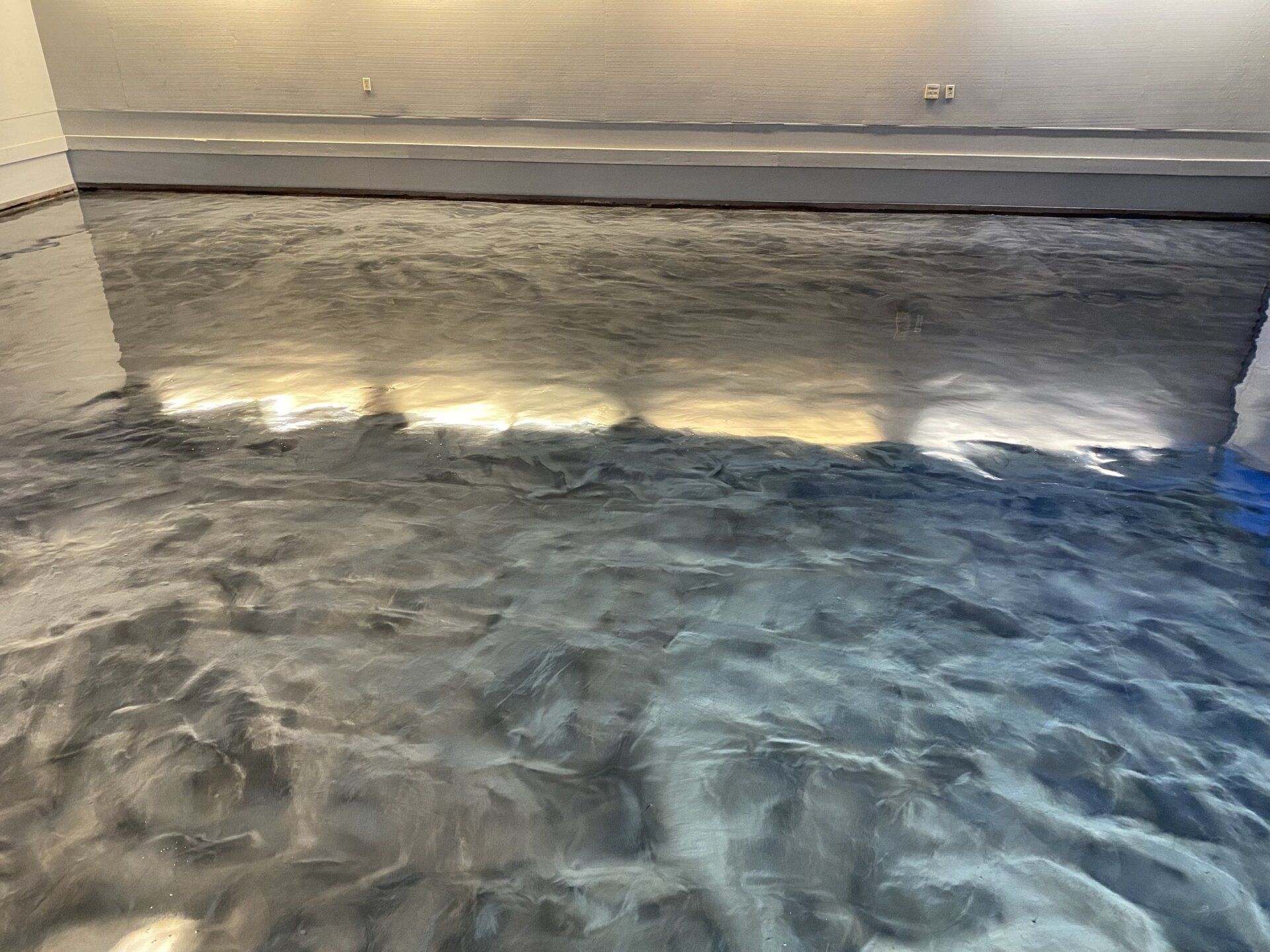 A close up of a metallic floor in a room.