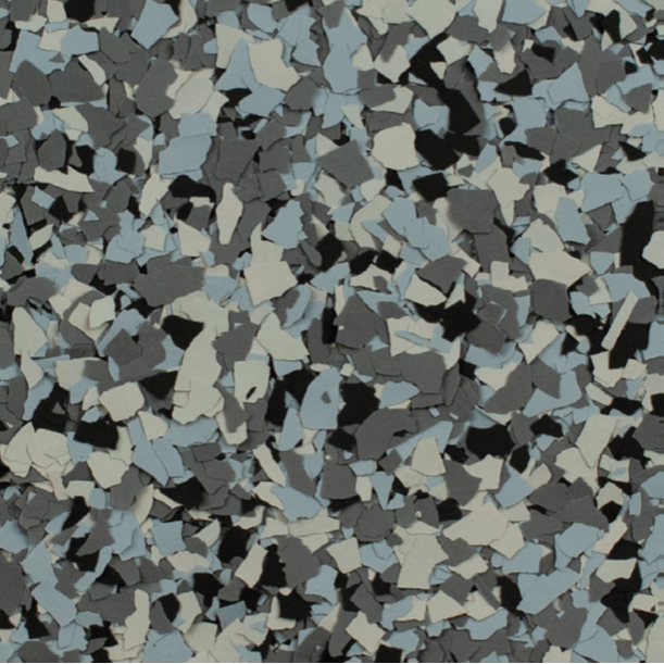 Close-up of a speckled floor coating with a mix of blue, gray, black, and white flakes.