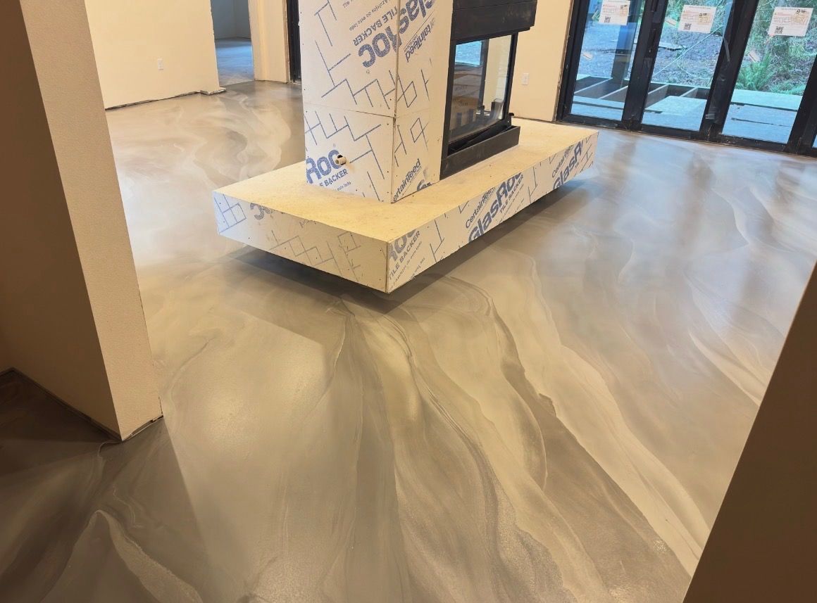 Empty interior with gray marble floor and a wrapped pedestal near glass doors