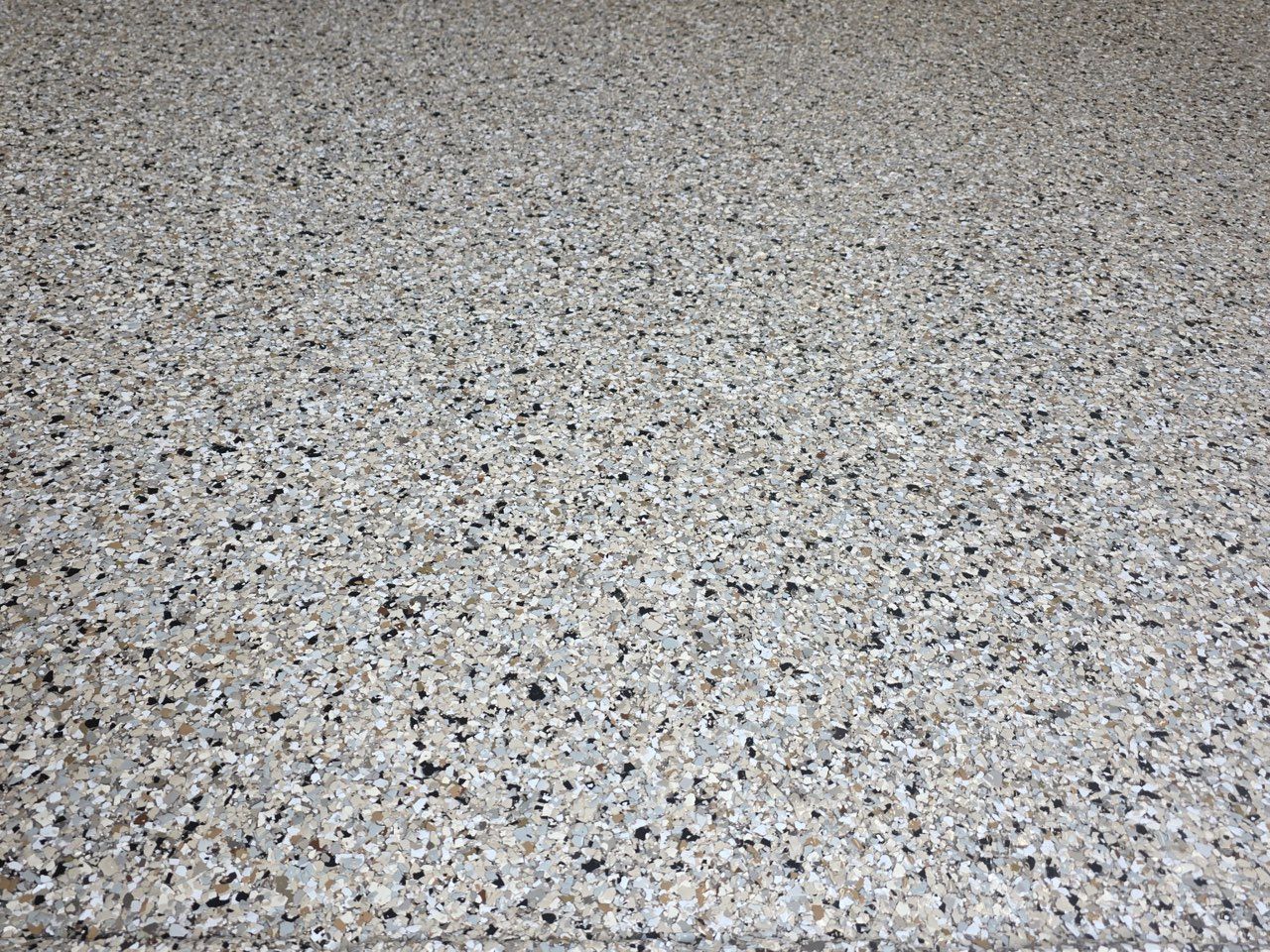 Speckled gray terrazzo floor surface filling the frame