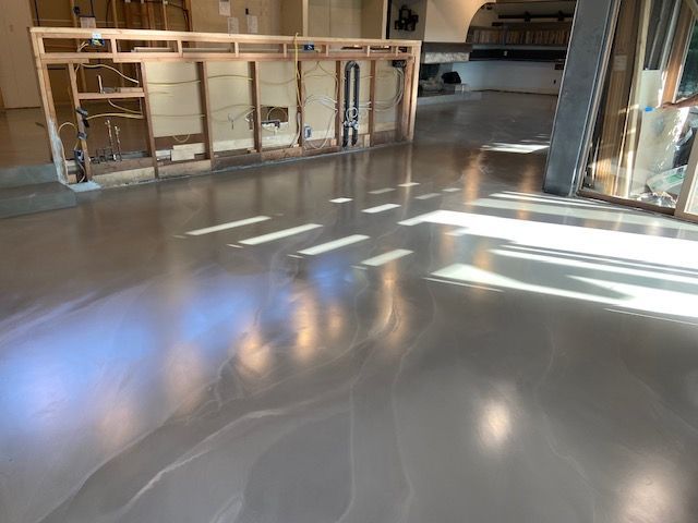 A shiny concrete floor in a room with a wooden frame.