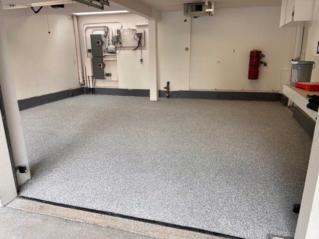 A garage with a gray floor and white walls