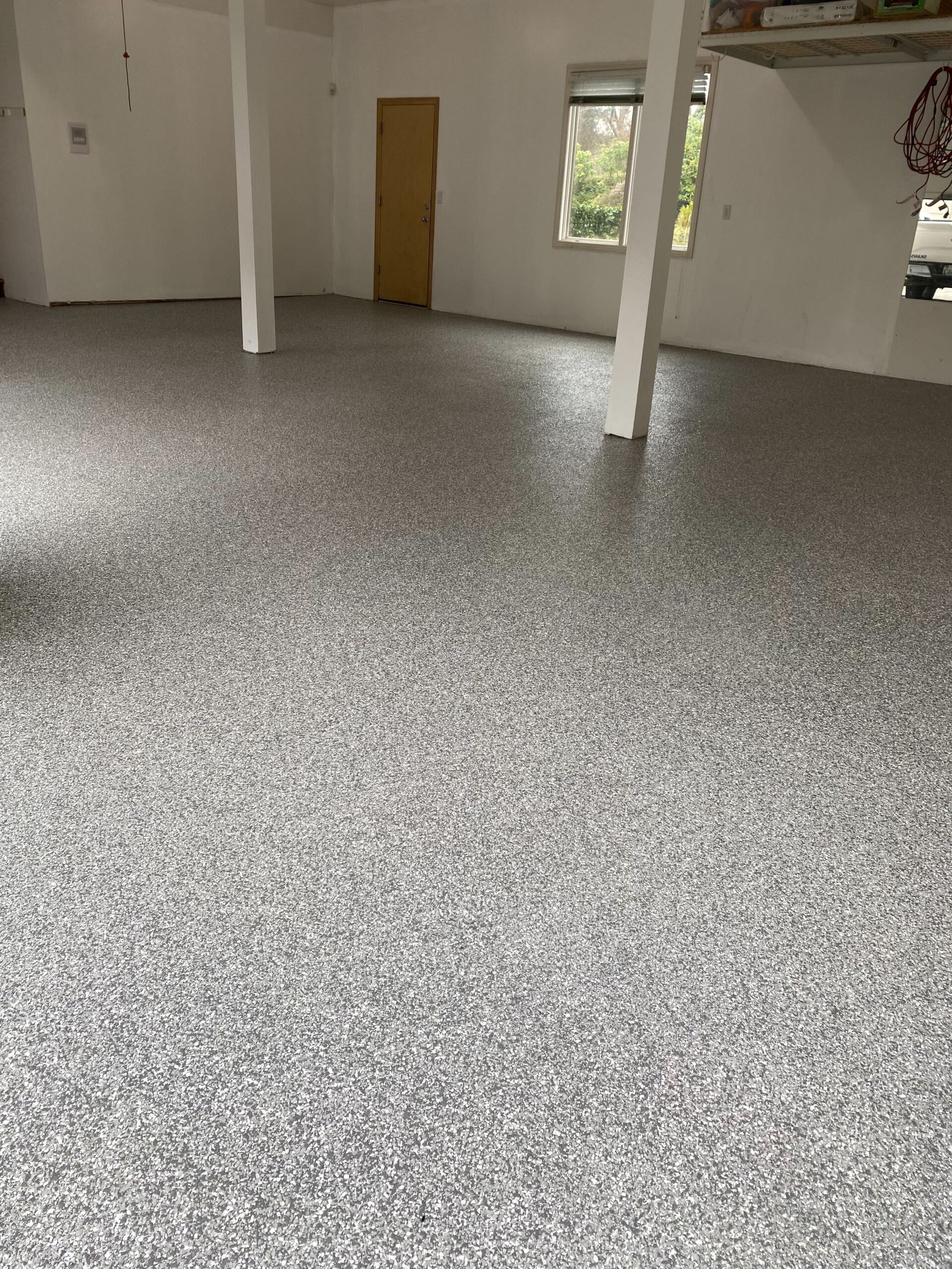 A large room with a gray floor and white walls.