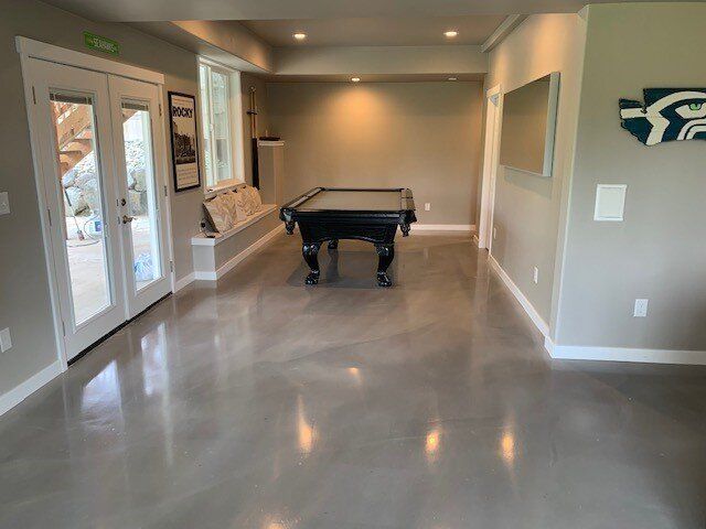 There is a pool table in the middle of the room.