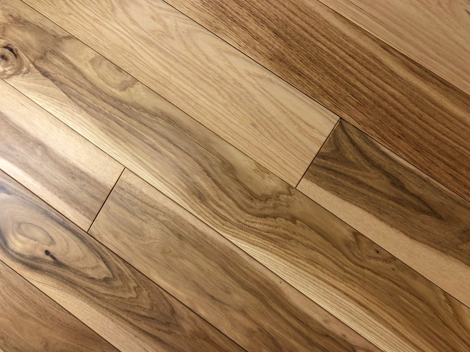 A close up of a wooden floor with a swirl pattern.