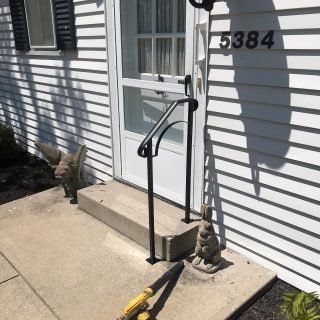 Accessible front entrance with ramp rails and address 5384 on a house