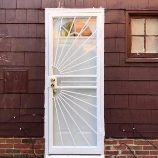 White security door with decorative bars on a brown house exterior