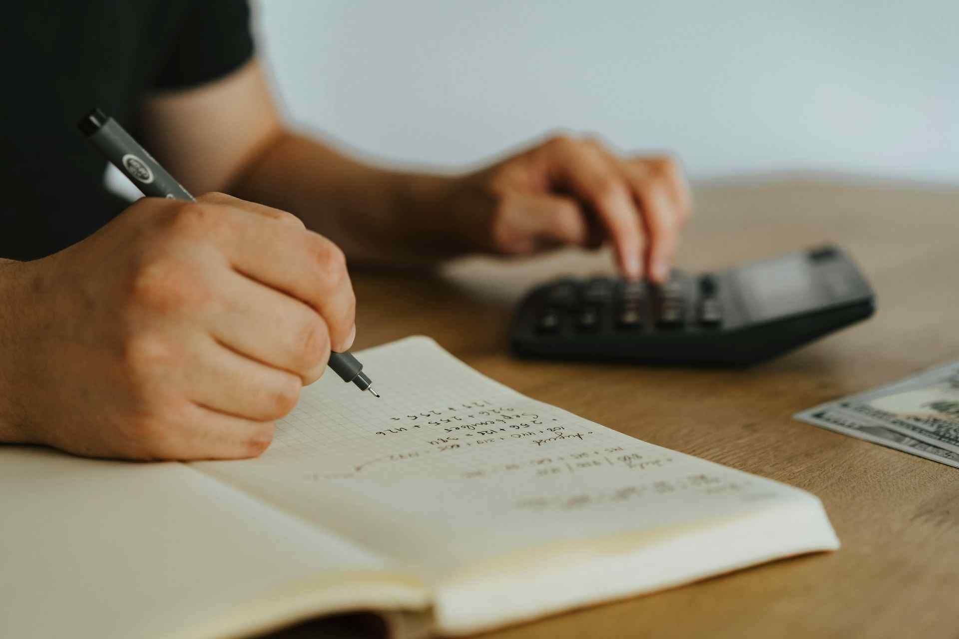 A photo of a person doing the bookkeeping for their company.