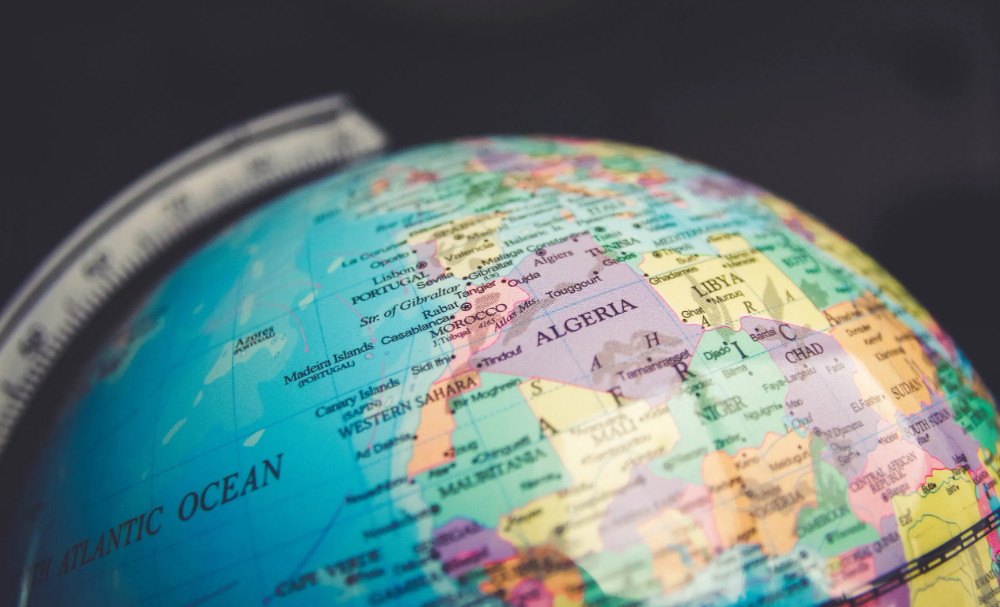 Close-up of a colorful globe showing Europe and Africa against a dark background.