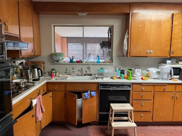 A kitchen with wooden cabinets and stainless steel appliances