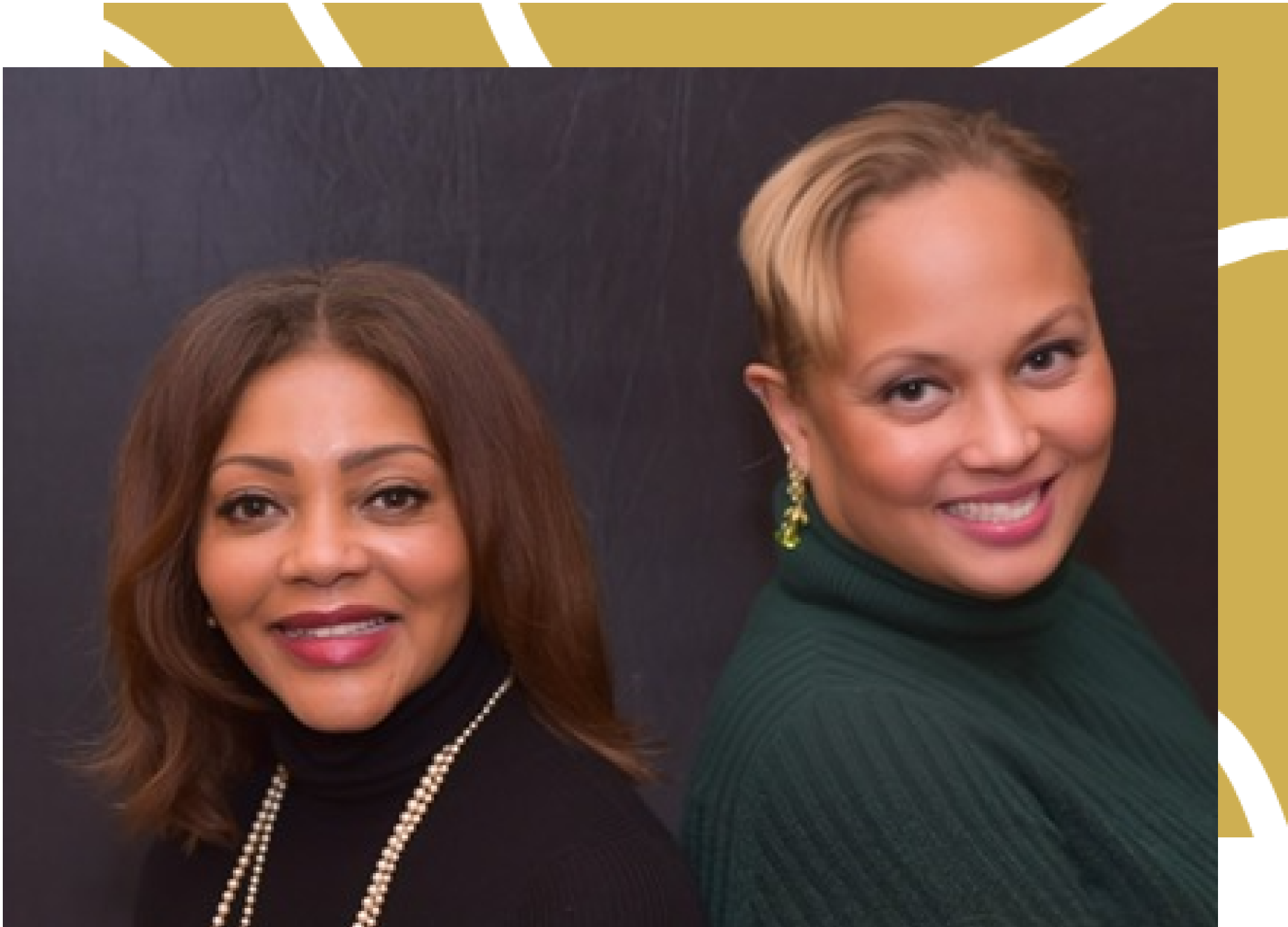 Two women are posing for a picture and one is wearing a green sweater