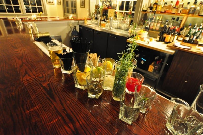 A bar with a lot of glasses on it