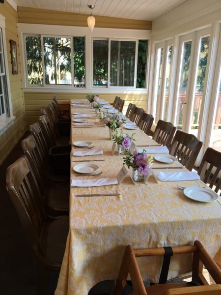 A long table with plates and flowers on it
