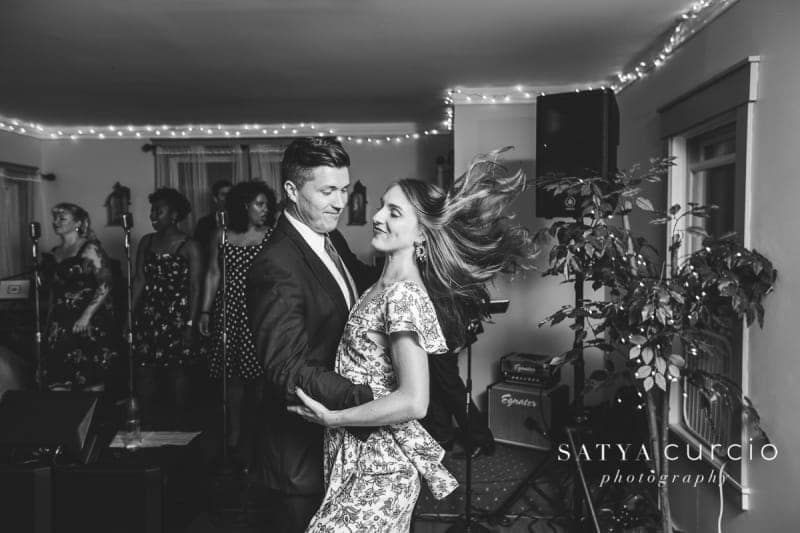 A black and white photo of a man and woman dancing in a room.