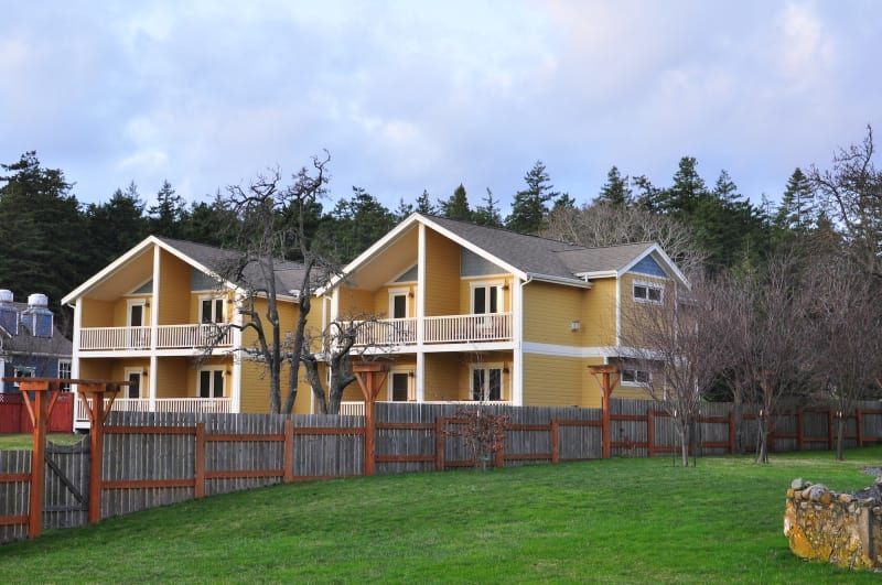 A row of houses with a wooden fence around them