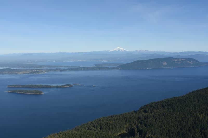 An aerial view of a large body of water with mountains in the background.