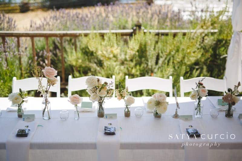 A long table with flowers in vases on it