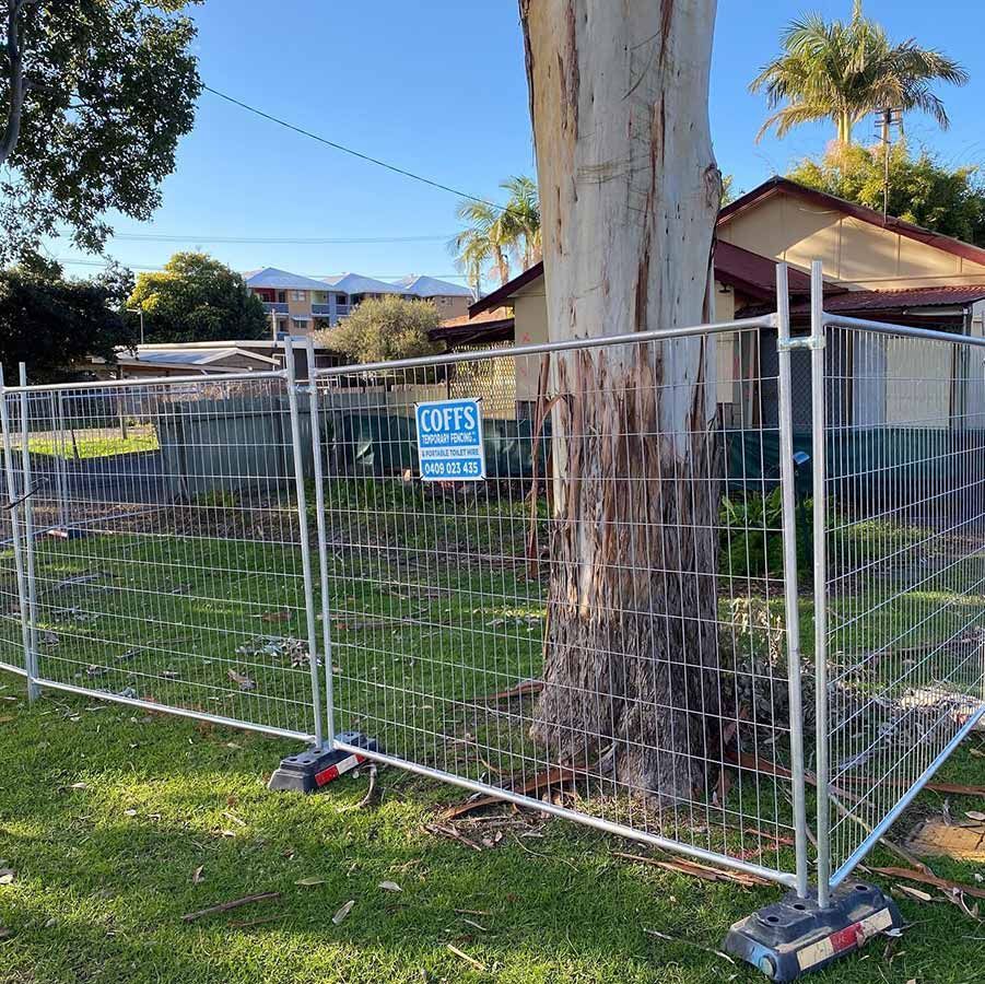 A Fence With A Sign That Says Lofts On It — Coffs Temporary Fencing Pty Ltd In Moonee Beach, NSW