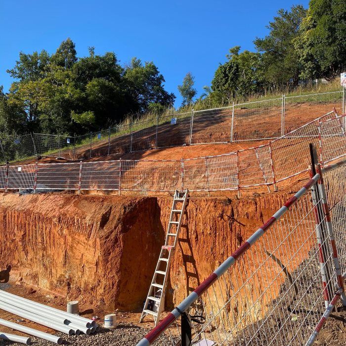 A Construction Site With A Ladder And A Fence — Coffs Temporary Fencing Pty Ltd In Moonee Beach, NSW