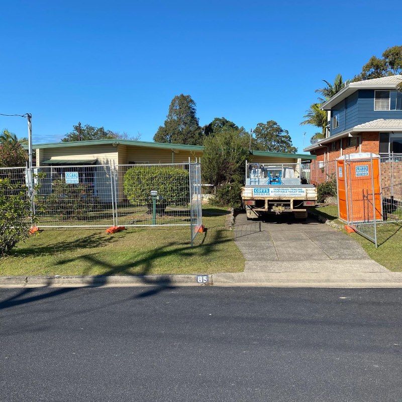 A White Truck Is Parked In Front Of A House — Coffs Temporary Fencing Pty Ltd In Moonee Beach, NSW