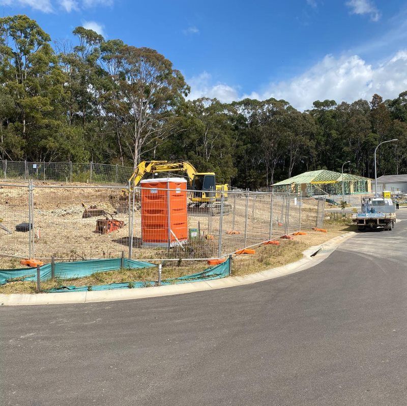 A Construction Site With A Truck Parked On The Side Of The Road — Coffs Temporary Fencing Pty Ltd In Dorrigo, NSW