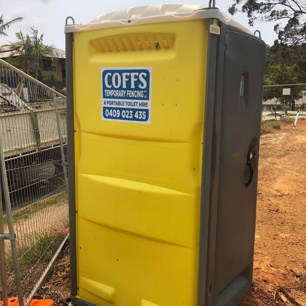 A Yellow Portable Toilet With The Word Coffs On It — Coffs Temporary Fencing Pty Ltd In Grafton, NSW