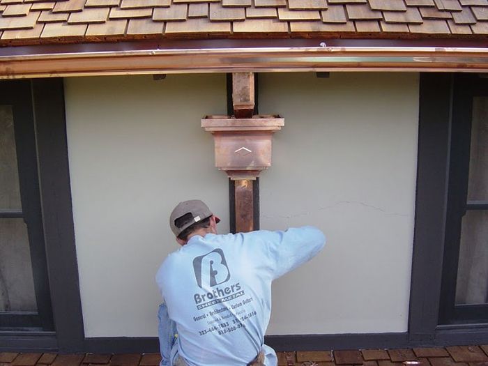 worker installing a gutter