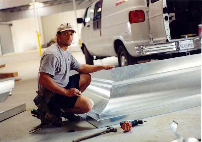 worker installing a gutter