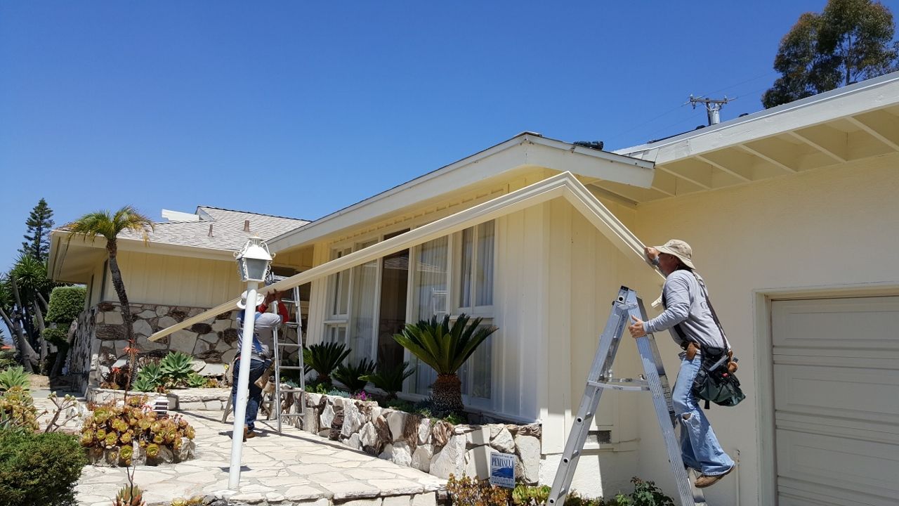 worker installing a gutter