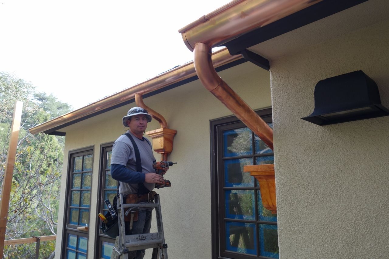 worker installing a gutter