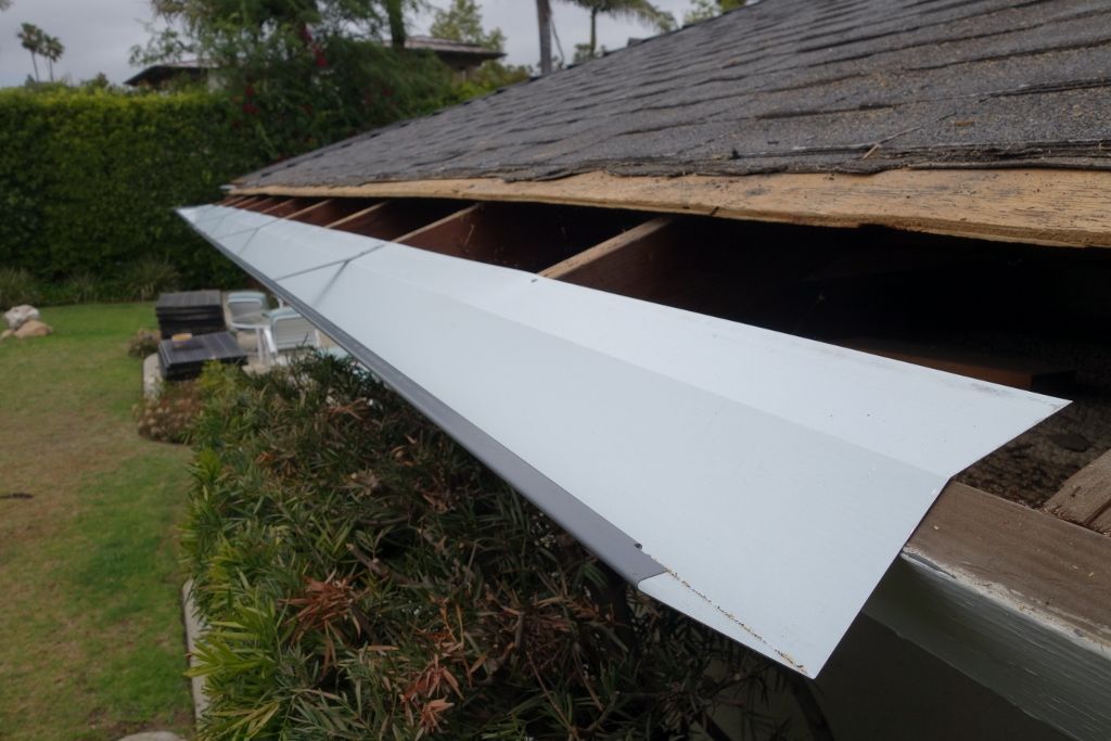 worker installing a gutter