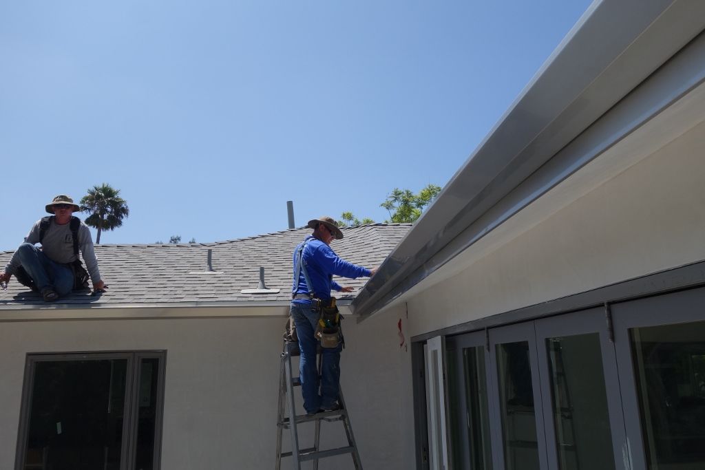 worker installing a gutter