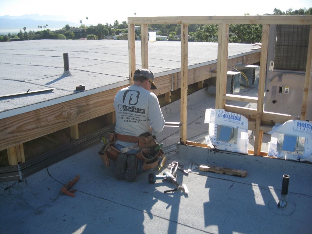 worker installing a gutter