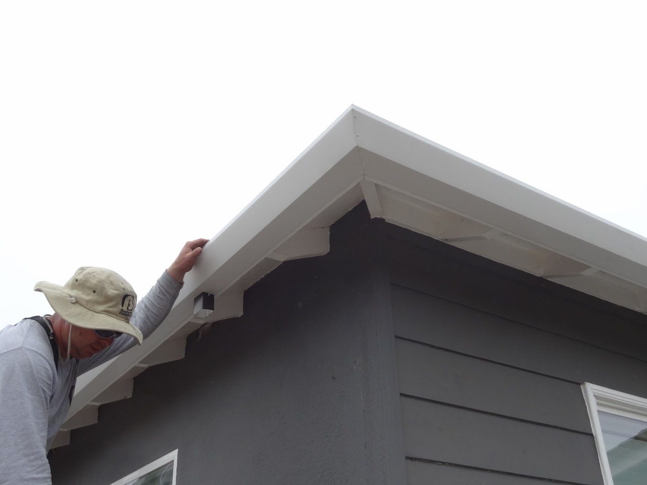 worker installing a gutter
