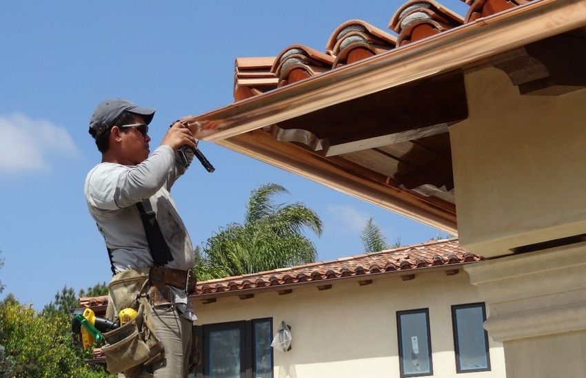 worker installing a gutter