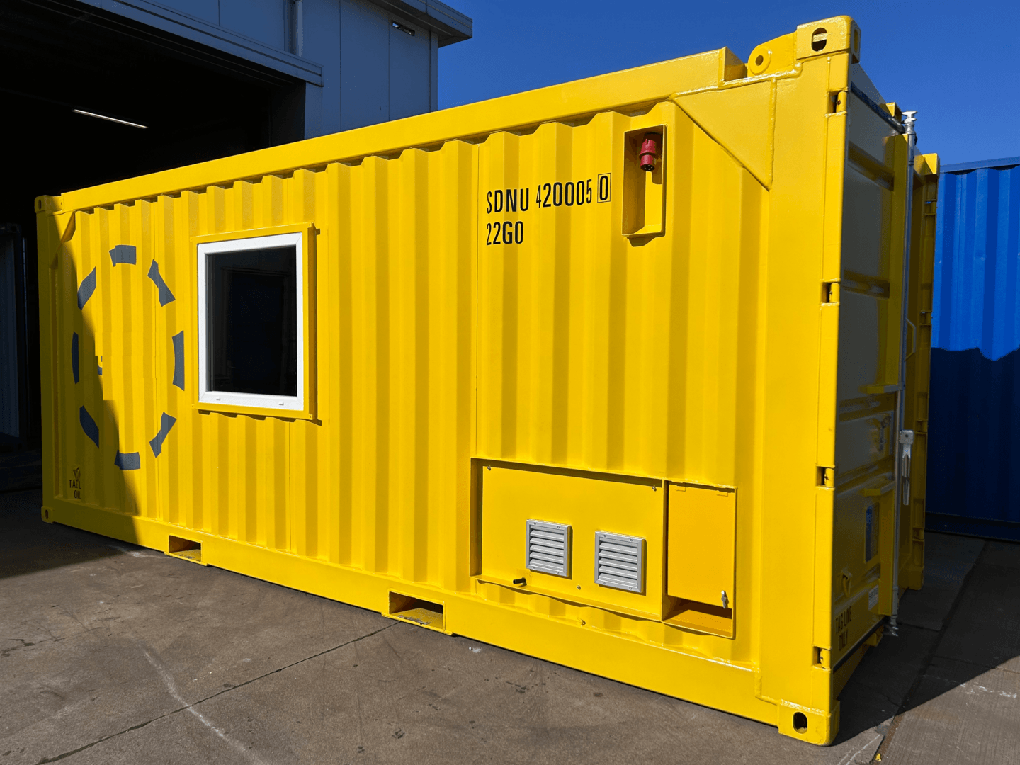 A yellow shipping container with a window on the side