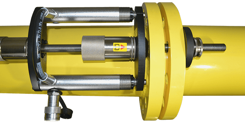 A yellow pipe with a metal device attached to it