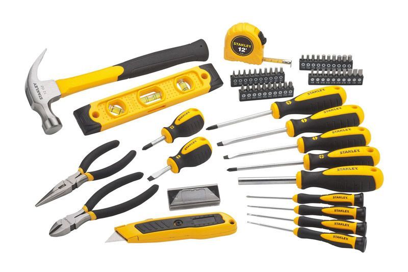 A set of yellow and black tools including a hammer , pliers , screwdrivers , and a tape measure.